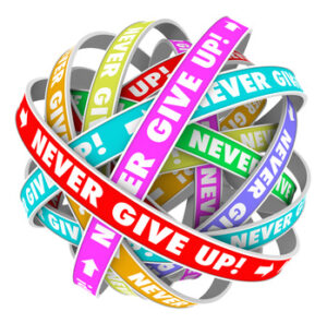 The words Never Give Up on an endless cycle of ribbons illustrating forward progress and neverending improvement